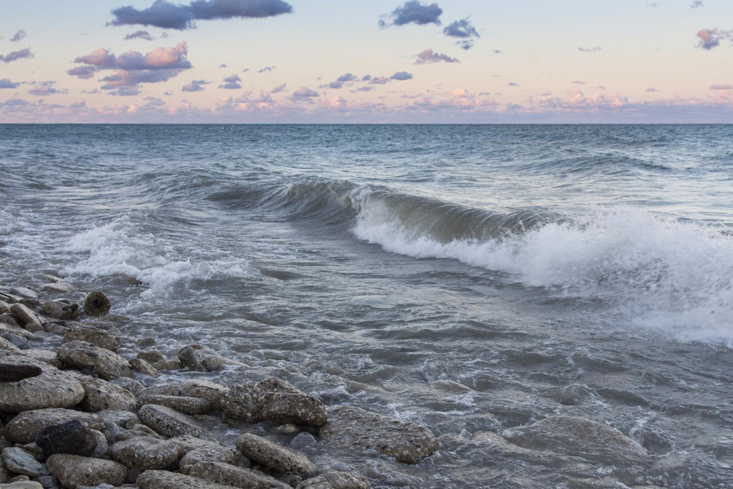 The sun rises over Lake Michigan on the <a href='http://8hyv.guidetohairlossproducts.com'>BETVLCTOR伟德登录</a> campus.